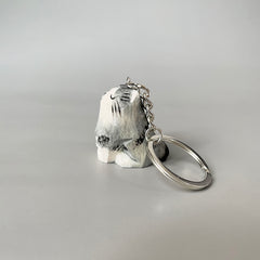 Right side view of a hand-painted wooden cat keychain