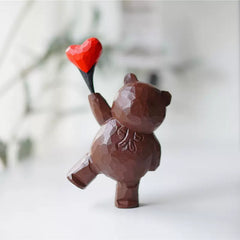 Bear figurine with heart balloon, hand-carved and painted.