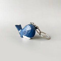 Side angle of the big head blue whale keychain, highlighting the intricate carvings and smooth finish.