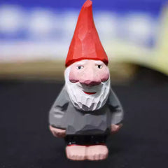 Front view of the hand‑carved Santa Claus wooden figurine wearing a red hat and gray coat, perfect for vintage holiday décor.