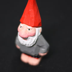 Close‑up of the hand‑made Santa figurine focusing on the pointed red hat and textured wooden surface of the Santa Claus wooden collectible.