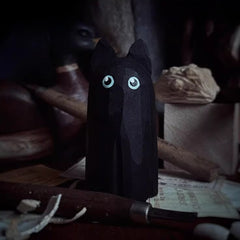 black cat figurine on desk