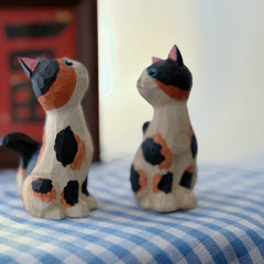 Svn Futures  calico cat figurine viewed from an angled side perspective