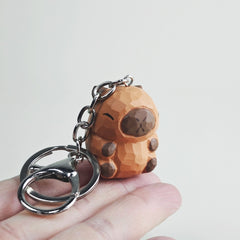 Capybara wooden keychain in hand