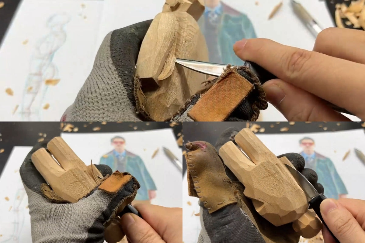 Using the flat side of a carving knife to refine and shape the wooden figure’s form.
