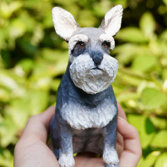 Hand-carved custom dog figurine of a gray schnauzer, showcasing unique fur details and lifelike expression.