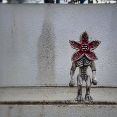 Demogorgon figure on a textured white step, blending horror and minimalism aesthetics.
