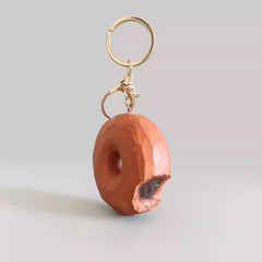 handmade wooden donut keychain with carved bite detail