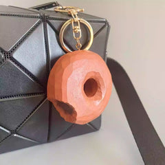 wooden donut keychain attached to handbag