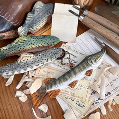 set of three wooden fish ornaments hanging together