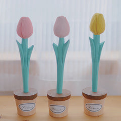 Three flower pens with pink, light pink, and yellow tulip shapes standing in small pots labeled "Flowers."