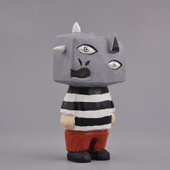 Side view of Guernica-style wooden figure with cubist features and striped shirt.