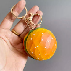 wooden hamburger keychain held in hand