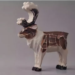 Hand-carved vintage reindeer figurine with detailed wooden texture, rustic Christmas holiday decor.
