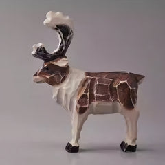 Side view of hand-carved vintage wooden reindeer figurine, perfect for rustic Christmas decorations.