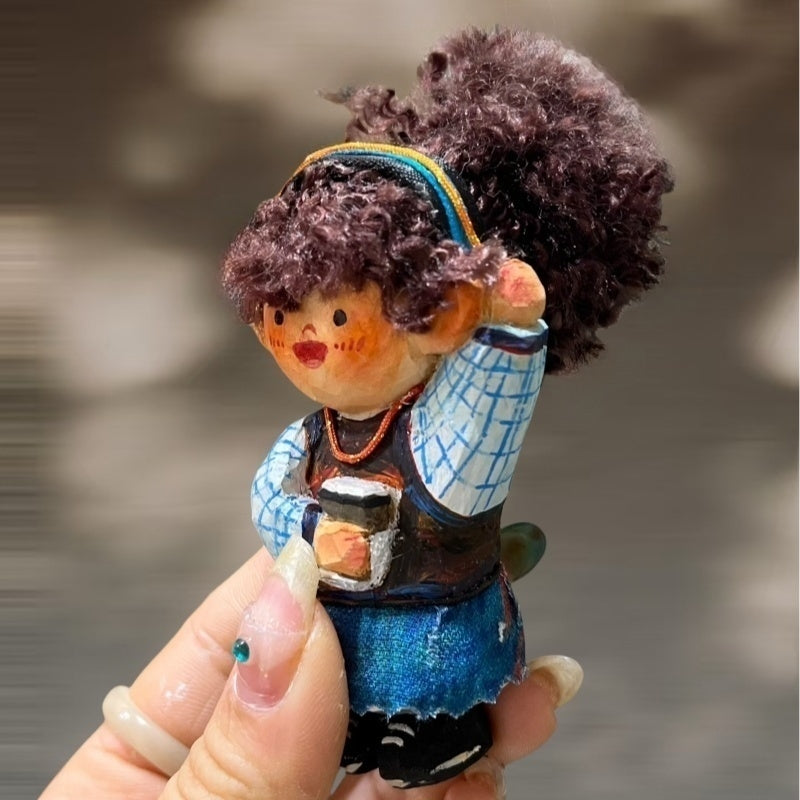 Handcrafted wooden doll keychain holding a coffee cup, carved wood body with curly cotton yarn hair