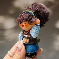Handcrafted wooden doll keychain holding a coffee cup, carved wood body with curly cotton yarn hair