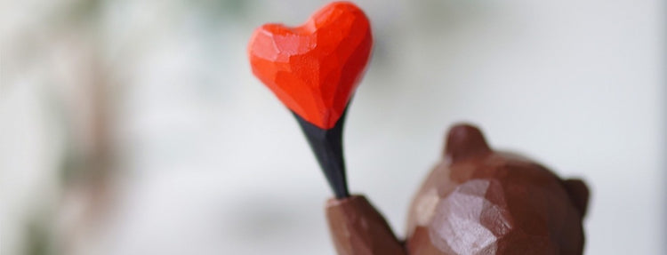 Homepage hero banner showing a hand-carved wooden heart, representing the warmth of handmade Svn Futures  gifts from Svn Futures .