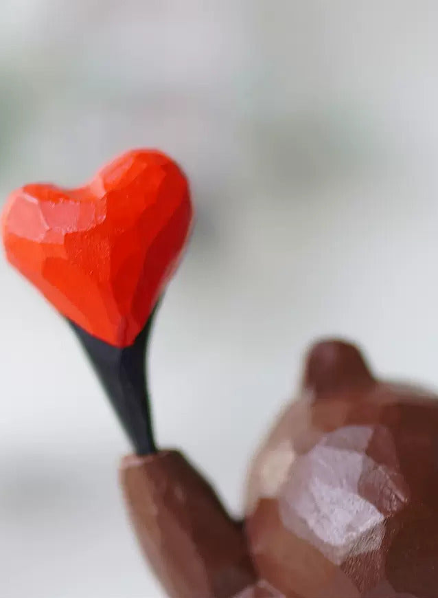 Homepage hero banner showing a hand-carved wooden heart, representing the warmth of handmade Svn Futures  gifts from Svn Futures .