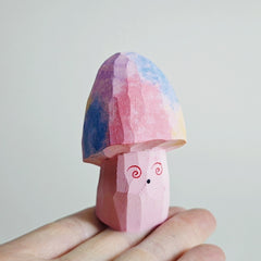 Hypno-shroom wooden figure displayed in hand