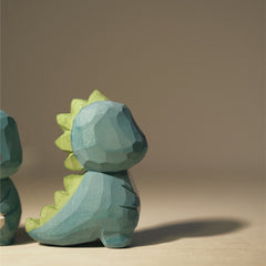 Side view of the dinosaur figure showing the natural details hand carved from wood.