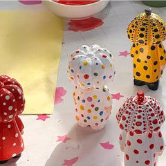 Polka dot pumpkin head wooden figurines in four color variations