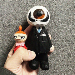 Hand carved wooden eyeball figure held in hand for size reference