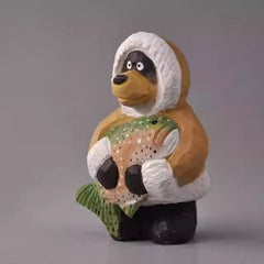 Rustic wooden bear figurine holding fish upright