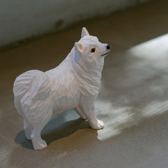 Side view of samoyed dog figurine