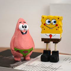 Colorful Spongebob and Patrick wooden statues displayed on a wooden surface.