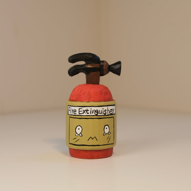 Fire extinguisher figurine front view showing cartoon face label