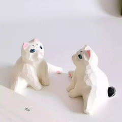 Side view of white cat figurine