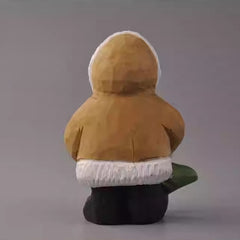 Back view of wooden bear figurine in hooded coat