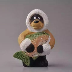 Svn Futures  bear figurine holding a fish wearing winter coat