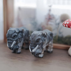 Svn Futures  elephant, hand-carved and painted figurine with vertical stripes.