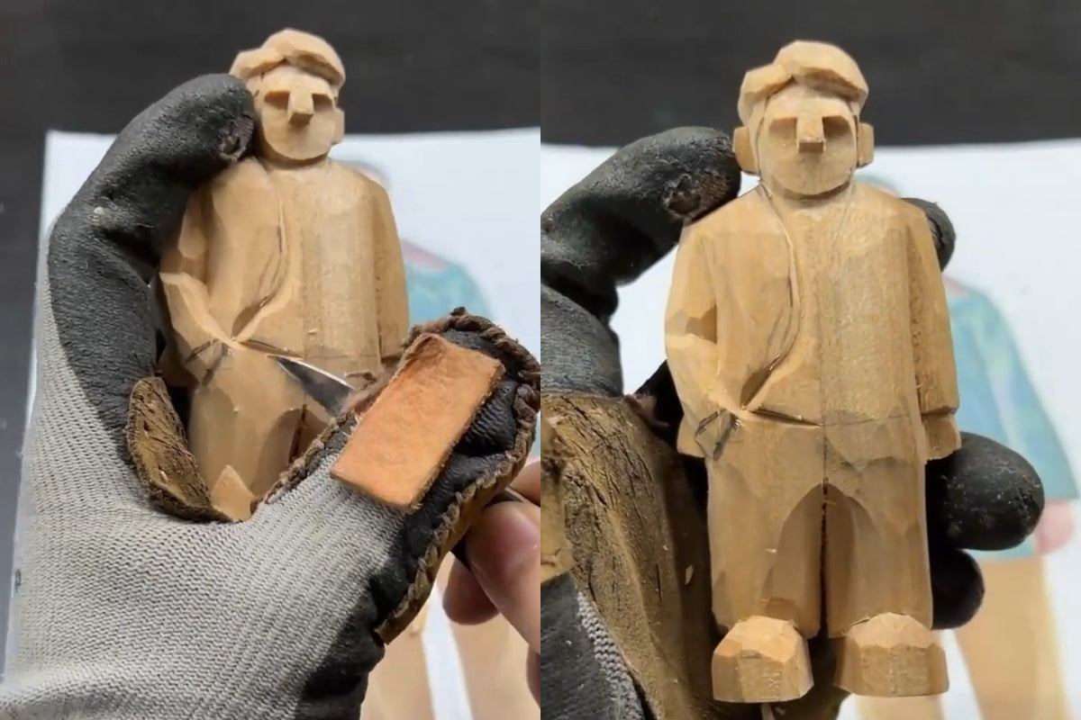 Close-up view of carving a coat hemline on a wooden figurine using detailed stop cuts for realistic fabric folds