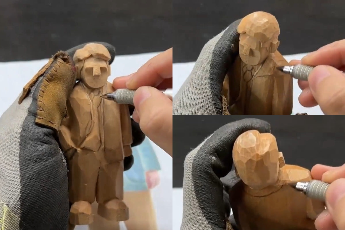 Pencil outlining of collar and necktie area during wooden figure detailing for a hand-carved figurine