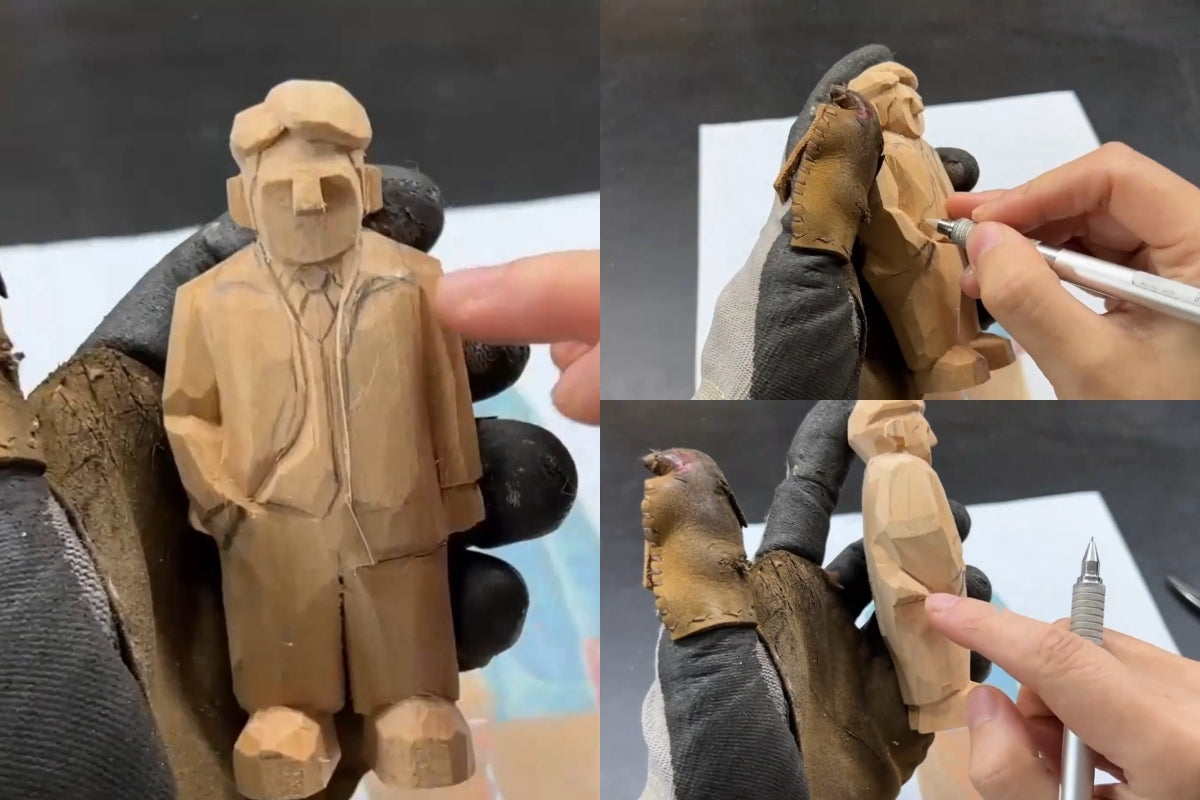 Final pencil markings of symmetrical collar, vest, and folds to refine coat texture on a wooden gift carving