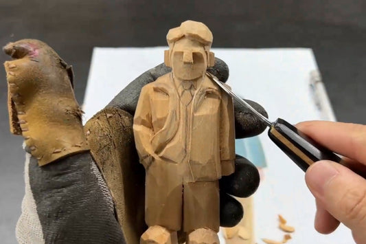 Detail carving of a handmade figurine’s shoulder, highlighting craftsmanship in creating Svn Futures  gifts with layered depth.