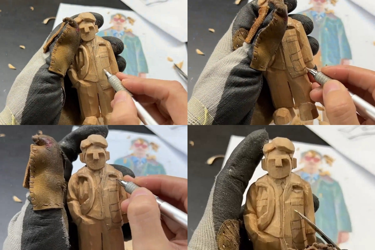 Marking pocket outlines on a wooden figurine using a pencil and reference image for accurate placement.