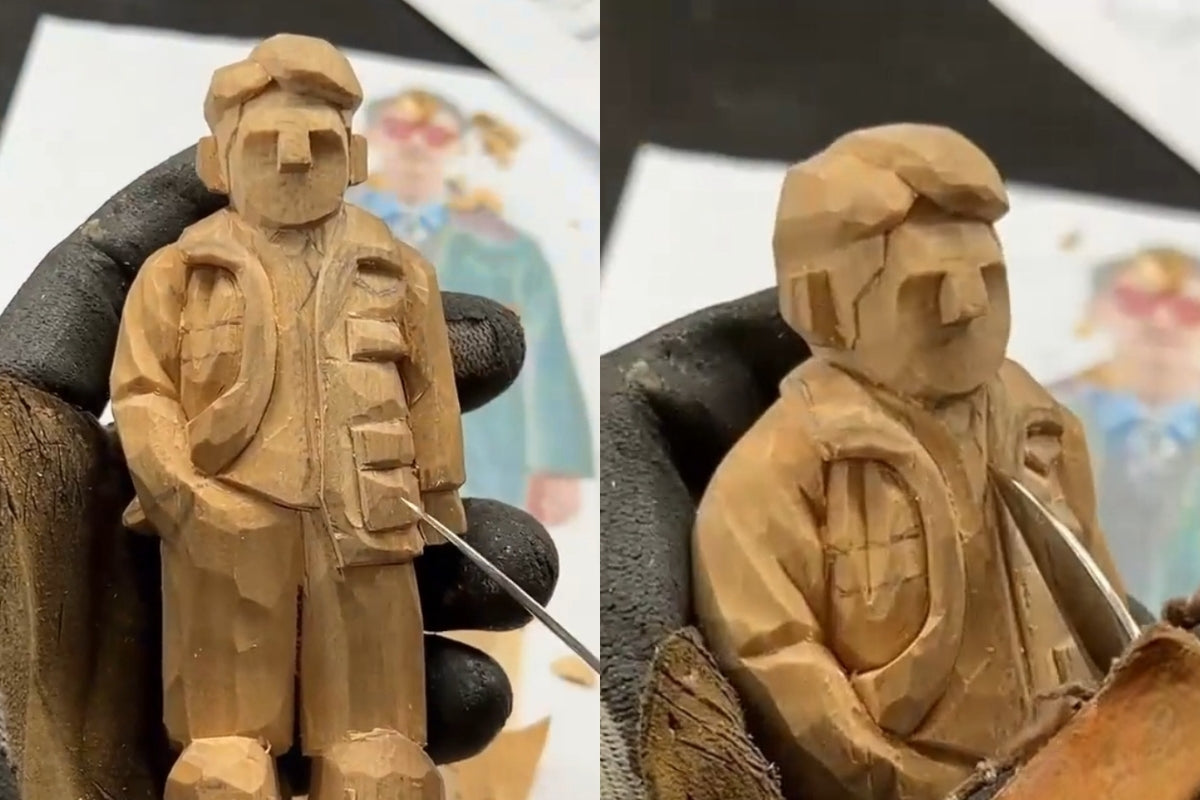 Refining inner shirt depth and jacket layers on a carved wooden gift figurine.