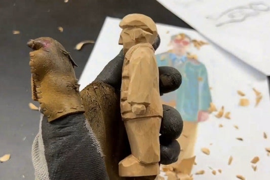 Side view of a hand-carved wooden figurine showing layered clothing and pocket details, crafted as part of a Svn Futures  gifts tutorial.