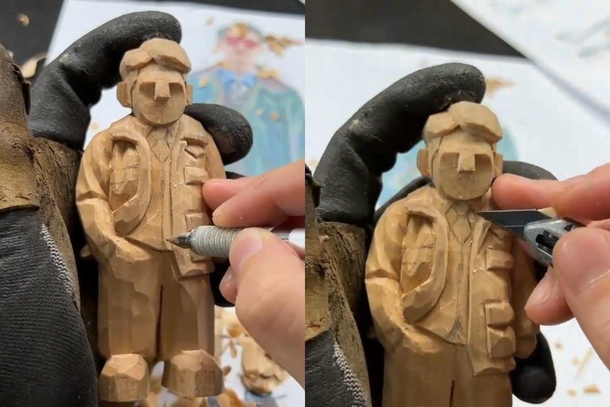 Carving clothing details on a wooden figurine using a craft knife during a wooden gift sculpture project.