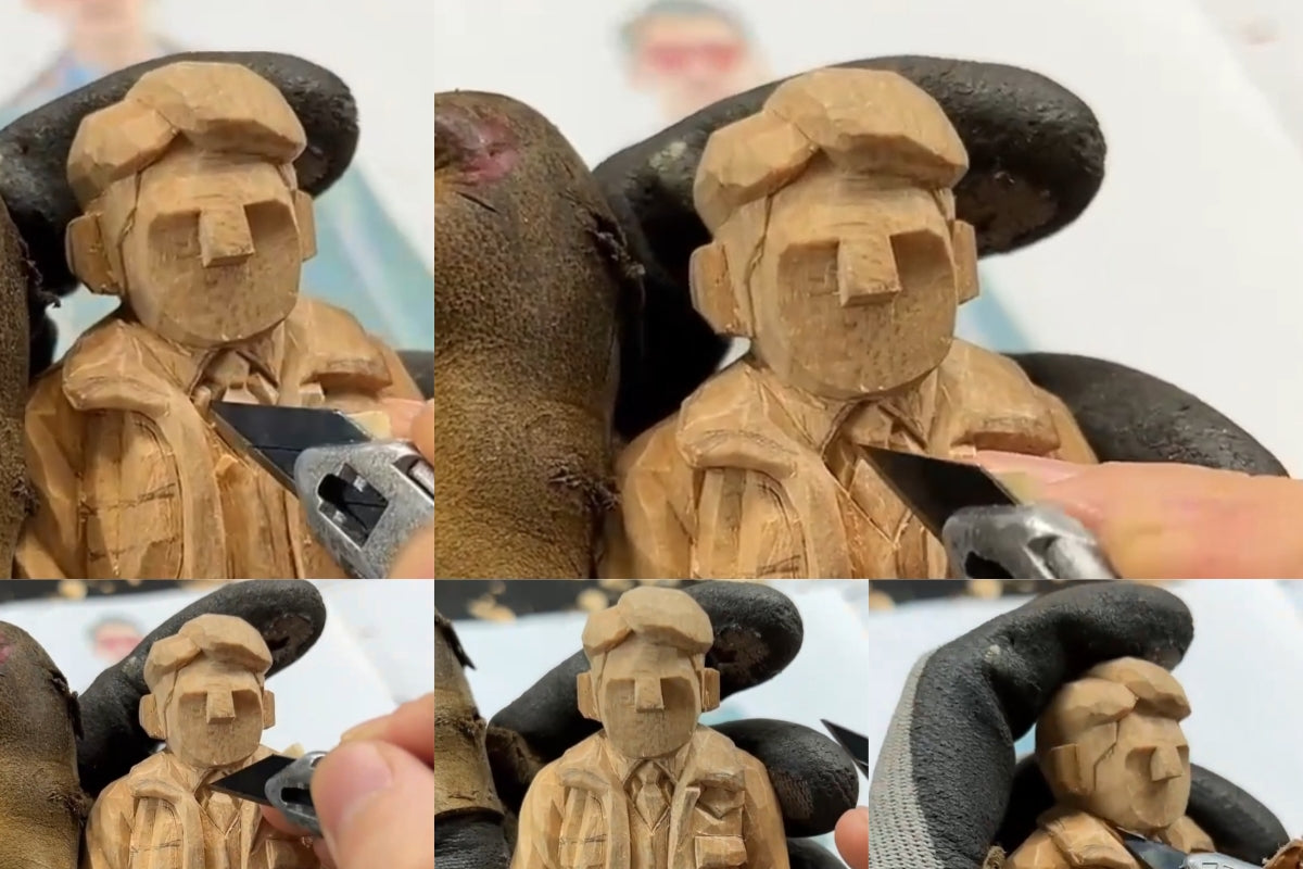 Refining the collar and facial boundary on a wooden sculpture to separate clothing from facial features.