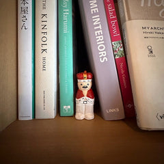 wooden nutcracker figurine displayed between books on shelf