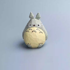 Front-facing wooden Totoro figurine with signature belly markings and handmade finish.
